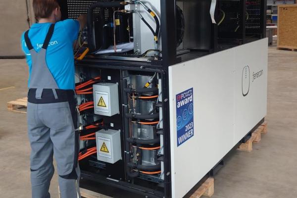 Person working on one of the energy storage units made from reused car batteries